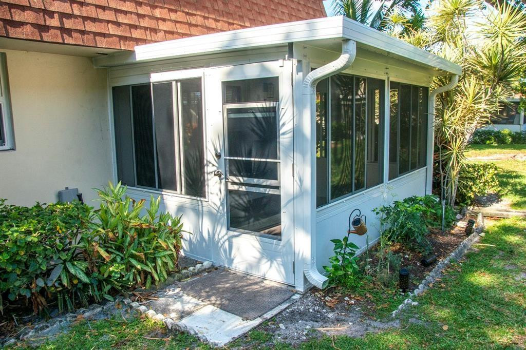 1991 Northeast 32nd Street, Unit 18 Lighthouse Point, FL 33064 - Photo 28 of 39 a front view of a house with a garden