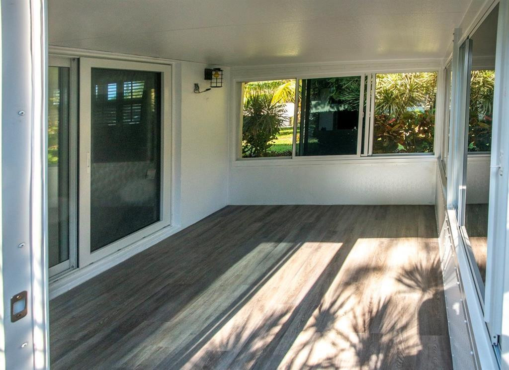 1991 Northeast 32nd Street, Unit 18 Lighthouse Point, FL 33064 - Photo 30 of 39 a view of an empty room with wooden floor and a window