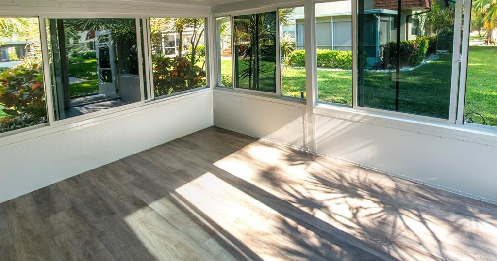 1991 Northeast 32nd Street, Unit 18 Lighthouse Point, FL 33064 - Photo 32 of 39 a view of a living room and floor to ceiling windows