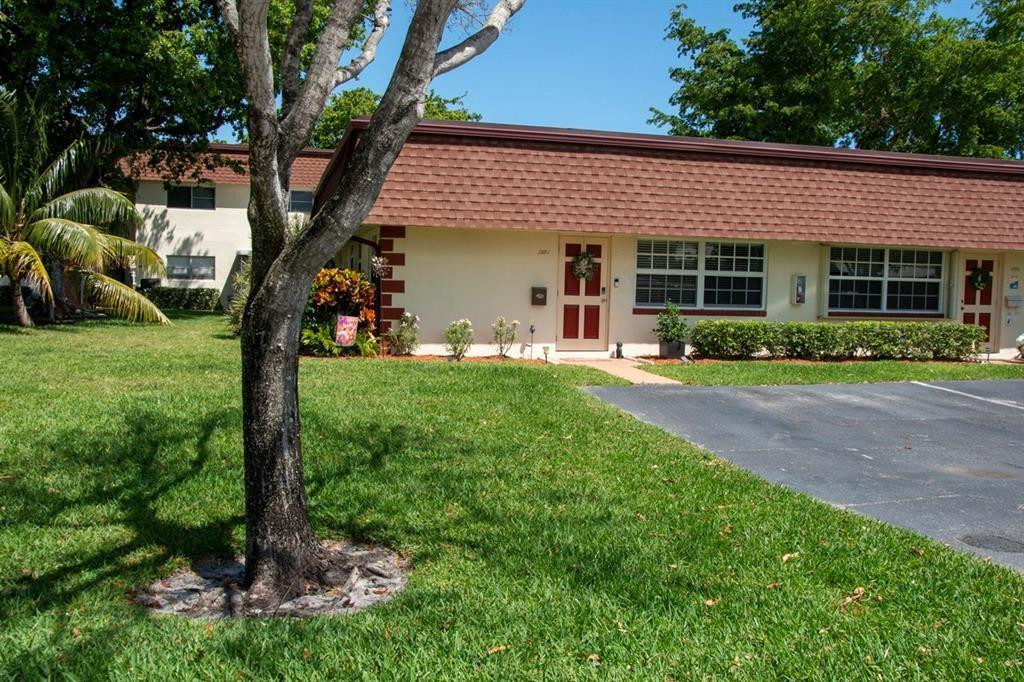 1991 Northeast 32nd Street, Unit 18 Lighthouse Point, FL 33064 - Photo 33 of 39 a front view of a house with garden