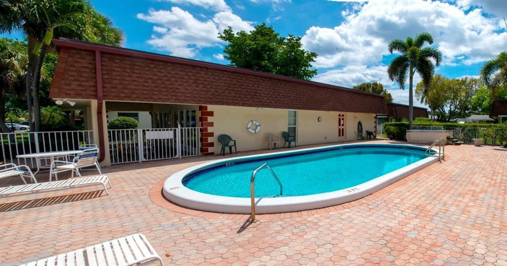 1991 Northeast 32nd Street, Unit 18 Lighthouse Point, FL 33064 - Photo 36 of 39 a view of a swimming pool with a patio