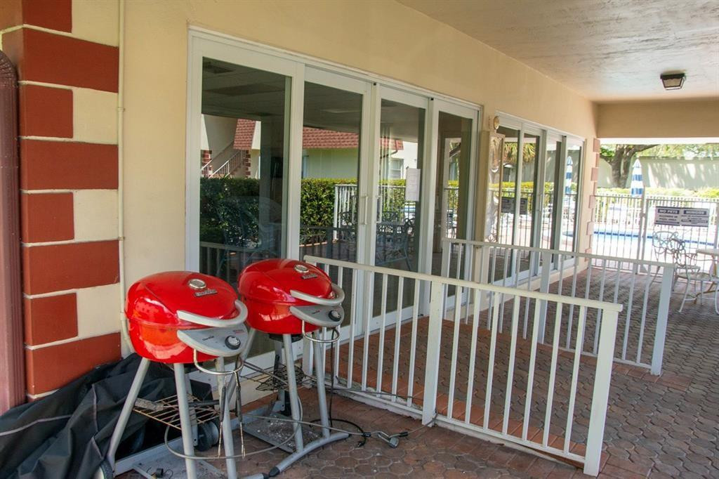 1991 Northeast 32nd Street, Unit 18 Lighthouse Point, FL 33064 - Photo 38 of 39 a view of a chairs and table in the patio