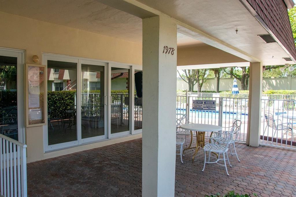 1991 Northeast 32nd Street, Unit 18 Lighthouse Point, FL 33064 - Photo 39 of 39 a view of a porch with chairs and backyard