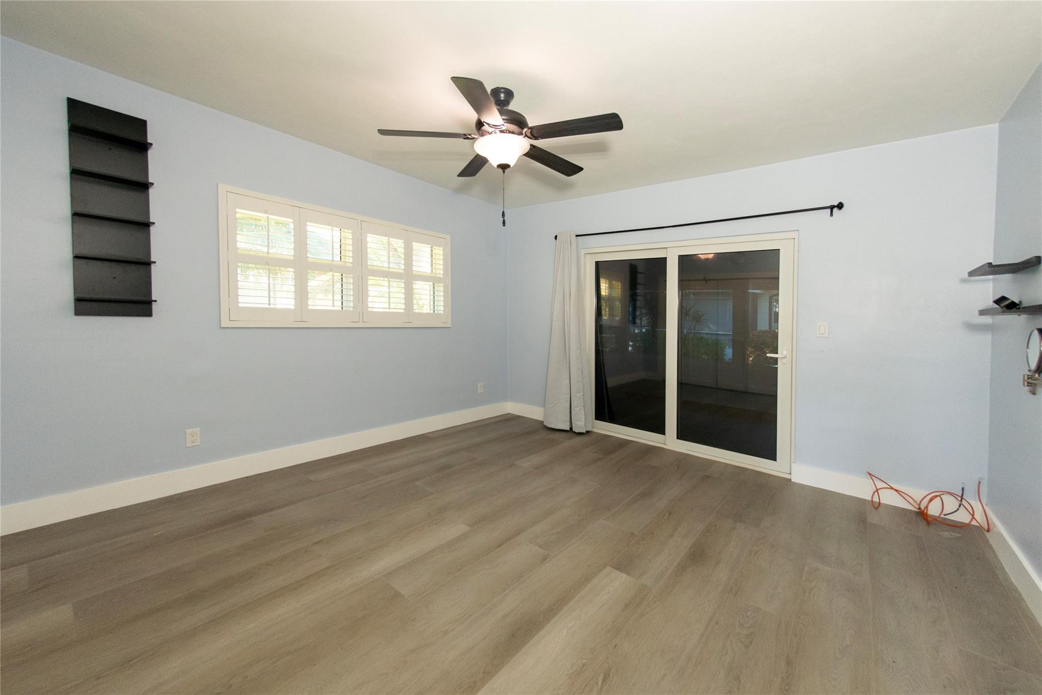 1991 Northeast 32nd Street, Unit 18 Lighthouse Point, FL 33064 - Photo 7 of 39 wooden floor in an empty room with a window