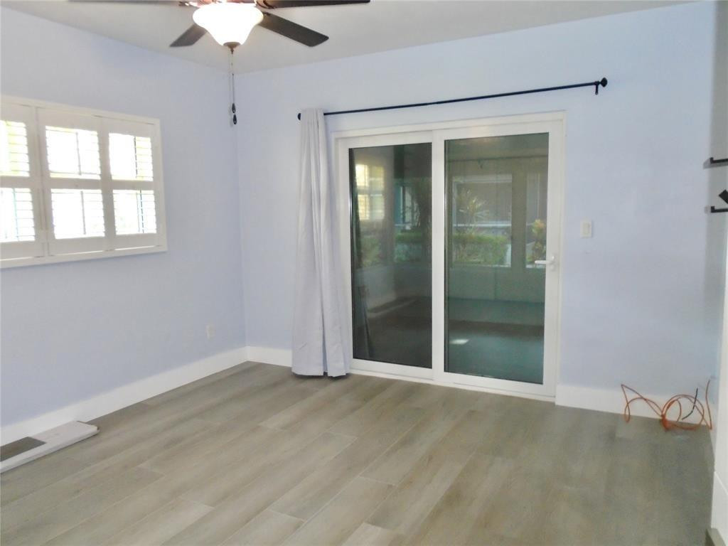 1991 Northeast 32nd Street, Unit 18 Lighthouse Point, FL 33064 - Photo 8 of 39 an empty room with chandelier fan