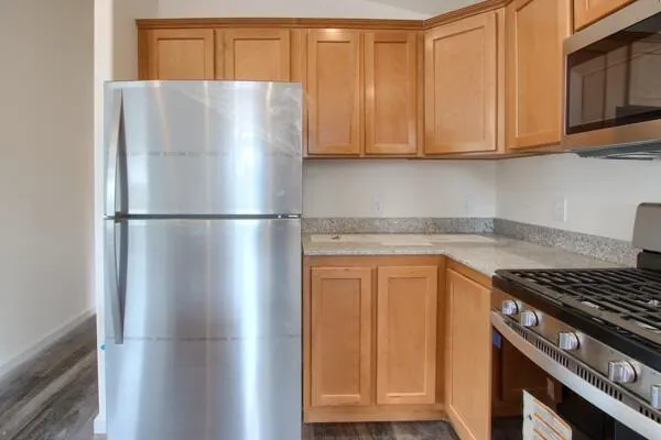 a white refrigerator freezer sitting inside of a kitchen