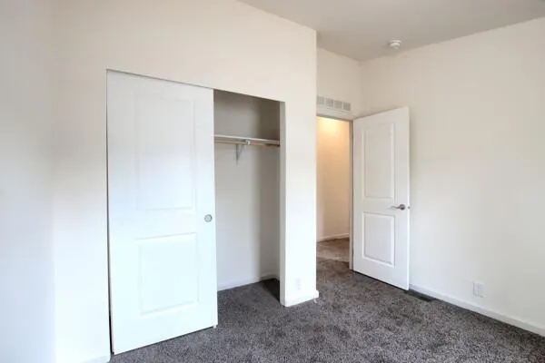 a view of an empty room with closet
