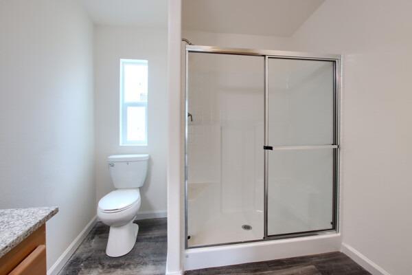 43555 Highway 41, Unit 53 Oakhurst, CA 93644 - Photo 18 of 28 a bathroom with a toilet a window and shower