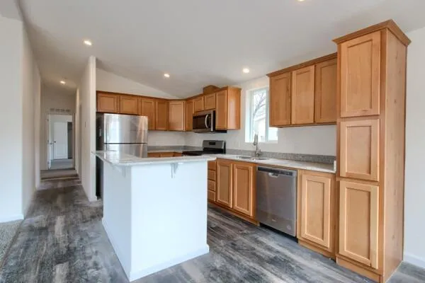 a kitchen with stainless steel appliances granite countertop a refrigerator sink and cabinets