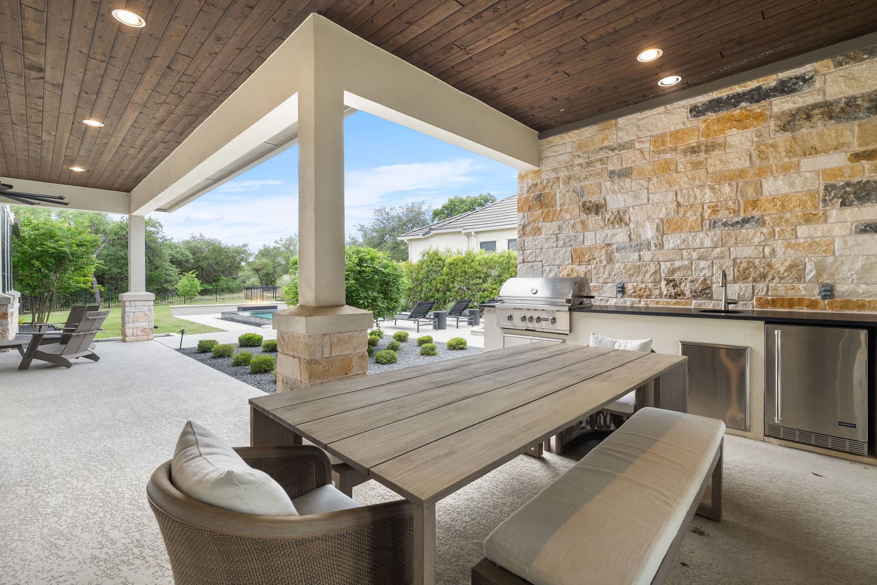 1106 Flint Ridge Trail Georgetown, TX 78628 - Photo 27 of 38 An inviting outdoor kitchen and dining area provides the perfect setting for al fresco entertaining, complete with a built-in grill and convenient beverage fridge.