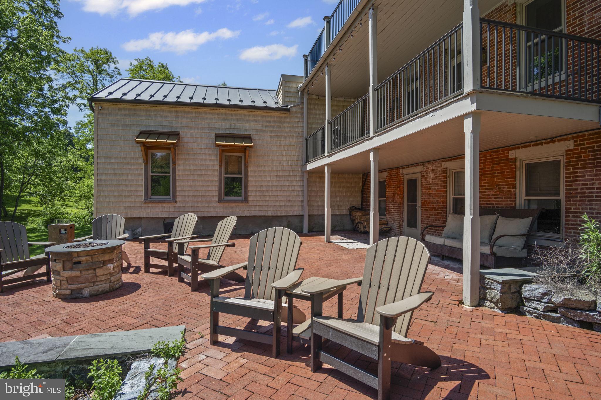154 Calvary Church Road Wrightsville, PA 17368 - Photo 12 of 89 a view of a patio with table and chairs and floor to ceiling window plants and trees