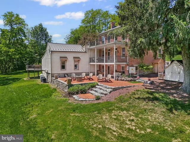 an aerial view of residential houses with outdoor space and trees