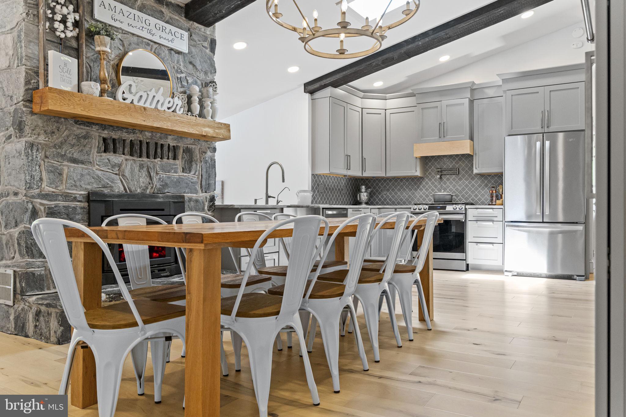 154 Calvary Church Road Wrightsville, PA 17368 - Photo 29 of 89 a kitchen with stainless steel appliances granite countertop a dining table chairs refrigerator and cabinets