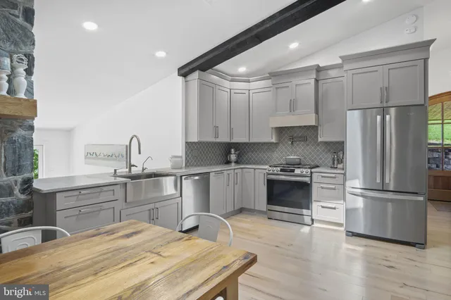 a spacious bathroom with a double vanity sink a mirror and a bathtub