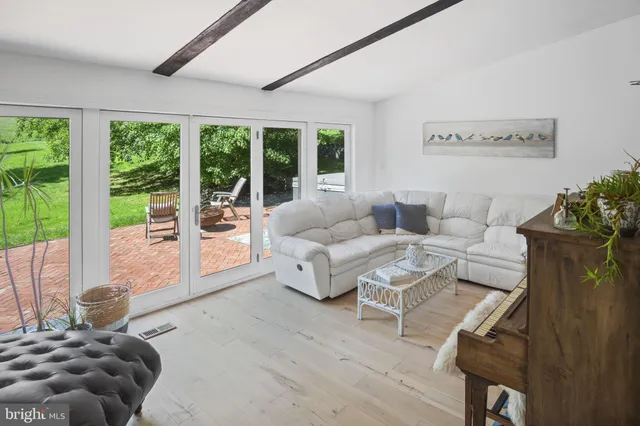 a spacious bathroom with a double vanity sink a mirror and a shower