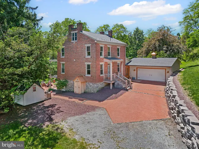 a view of a patio with table and chairs under an umbrella