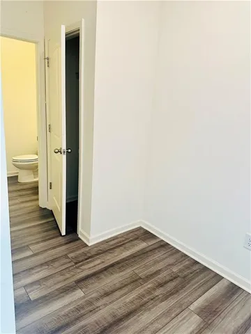 a view of a room with wooden floor and bathroom