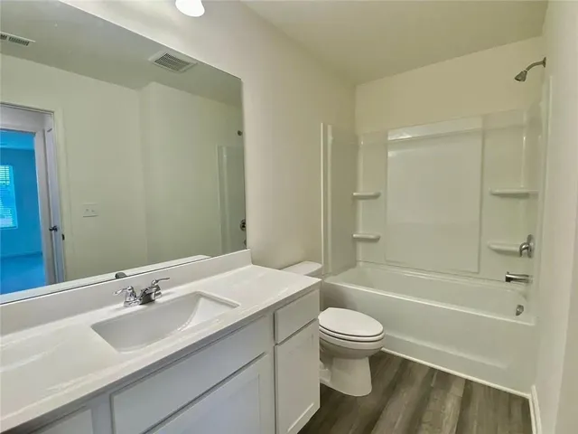 a view of house with swimming pool and seating