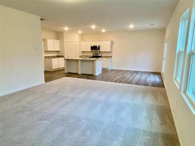 a view of kitchen with wooden floor and electronic appliances