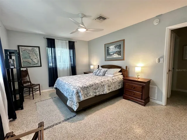 a bedroom with a bed and a table in it