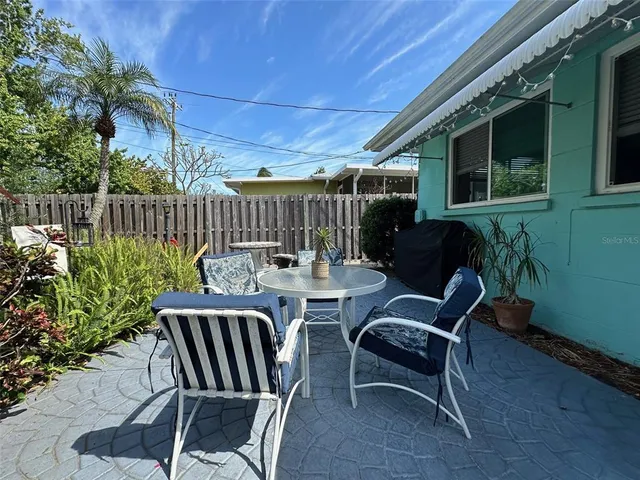 a view of a backyard with furniture and outdoor seating