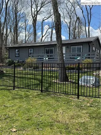a view of a house with a large window and a garden