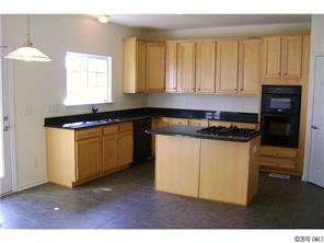 152 Lighthouse Road Mount Holly, NC 28120 - Photo 4 of 16 a kitchen with granite countertop white cabinets and black appliances