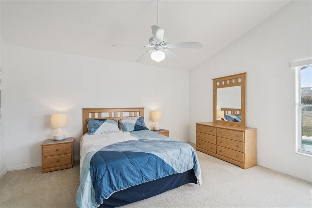 1202 Winding Cypress Court Kissimmee, FL 34746 - Photo 14 of 41 a spacious bedroom with a bed and a dresser