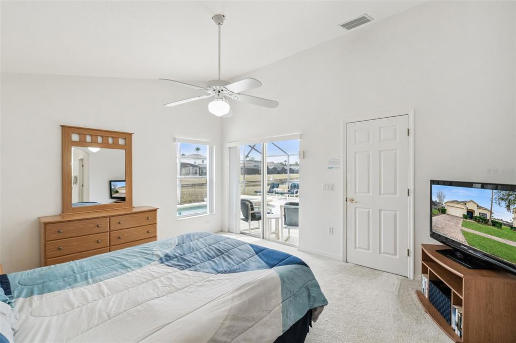 1202 Winding Cypress Court Kissimmee, FL 34746 - Photo 15 of 41 a bedroom with a bed and a dresser