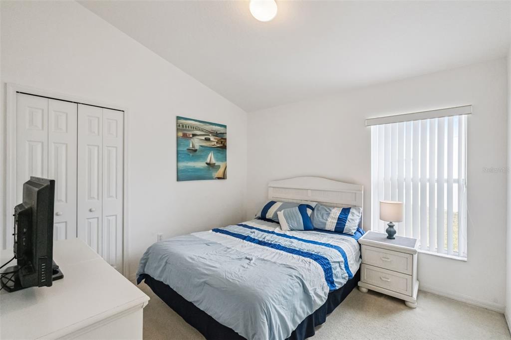 1202 Winding Cypress Court Kissimmee, FL 34746 - Photo 17 of 41 a bedroom with a bed and a window