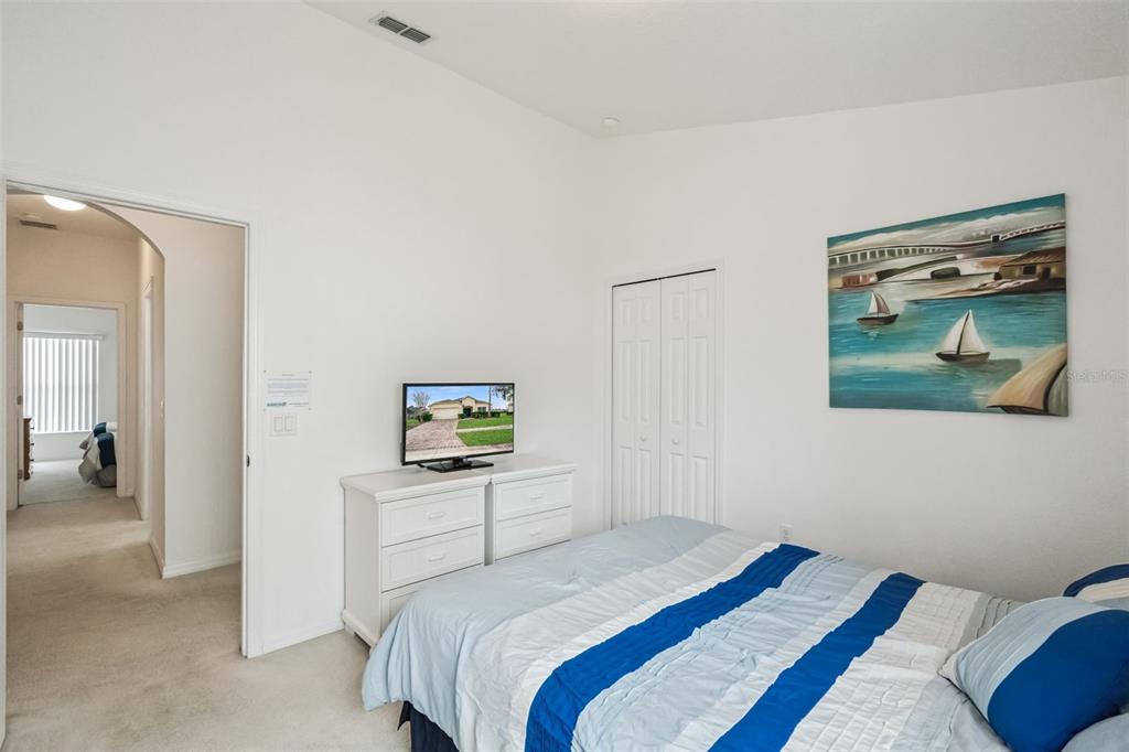 1202 Winding Cypress Court Kissimmee, FL 34746 - Photo 18 of 41 a bedroom that has a bed and a painting on the wall