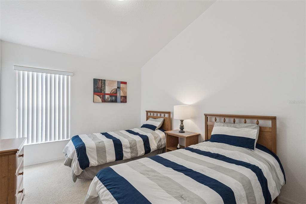 1202 Winding Cypress Court Kissimmee, FL 34746 - Photo 19 of 41 a bedroom with two beds and a large window