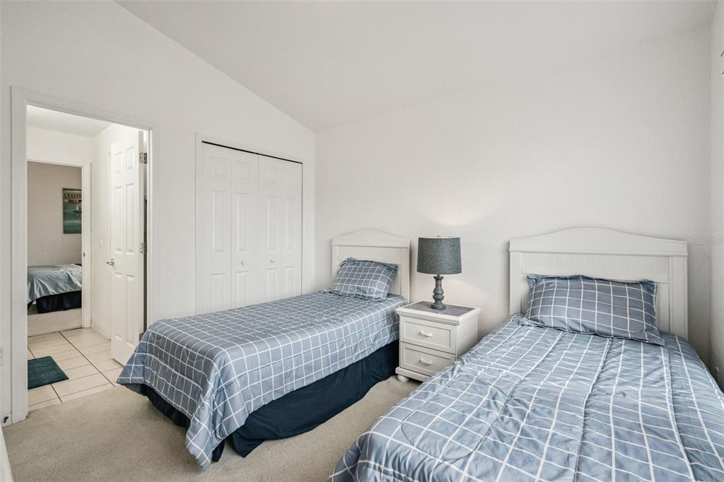 1202 Winding Cypress Court Kissimmee, FL 34746 - Photo 21 of 41 a bedroom with two beds and a lamp