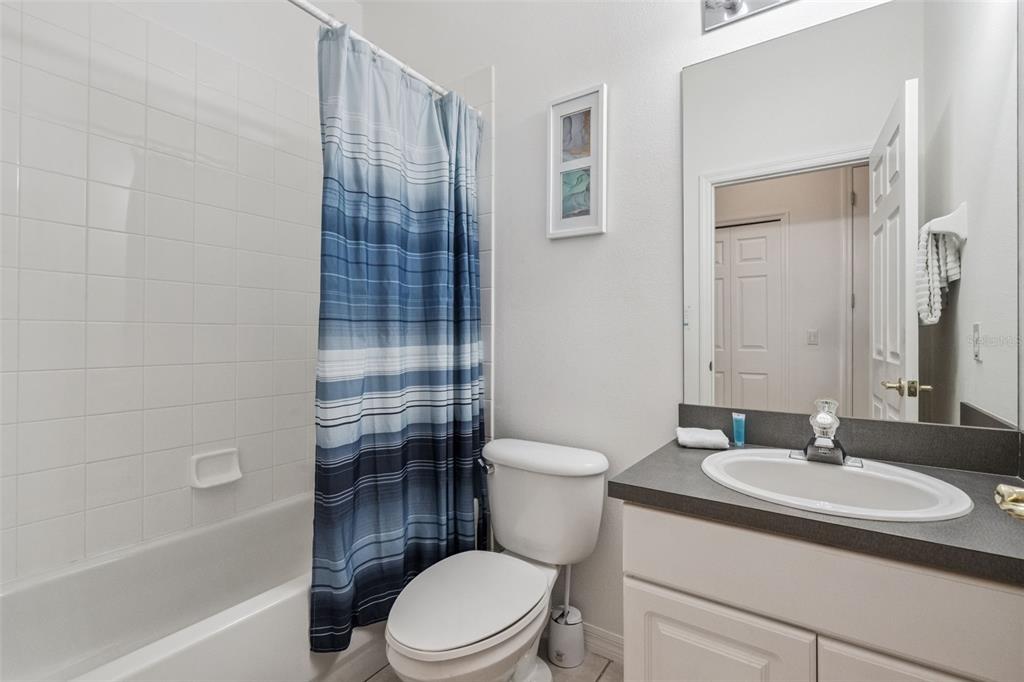 1202 Winding Cypress Court Kissimmee, FL 34746 - Photo 24 of 41 a bathroom with a sink toilet and shower