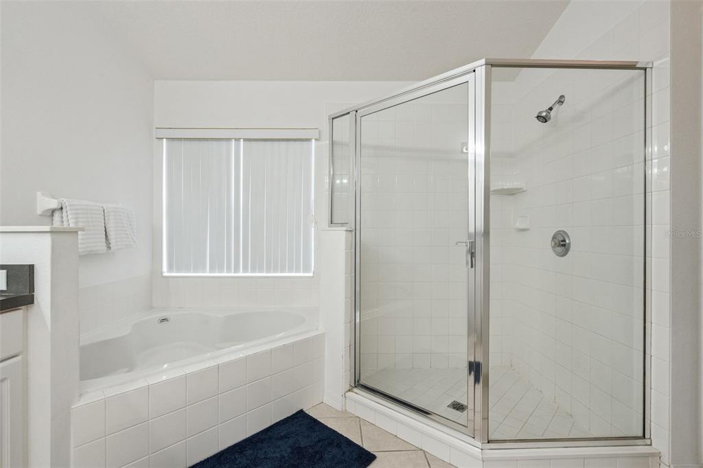 1202 Winding Cypress Court Kissimmee, FL 34746 - Photo 25 of 41 a bathroom with a bathtub shower and toilet