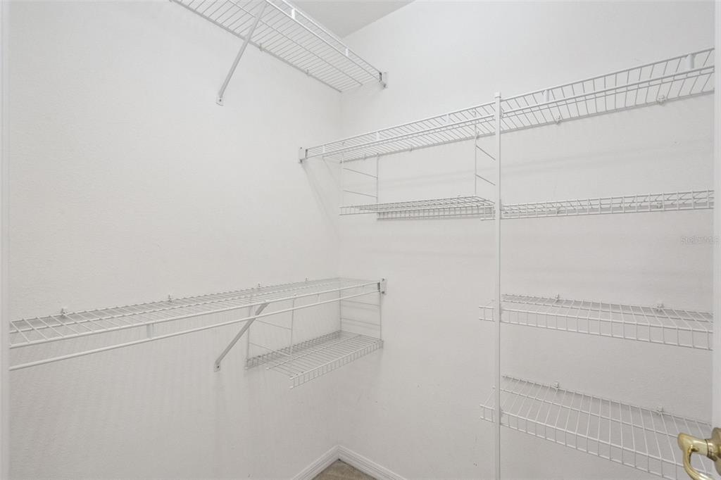 1202 Winding Cypress Court Kissimmee, FL 34746 - Photo 28 of 41 a view of a room with racks on the wall