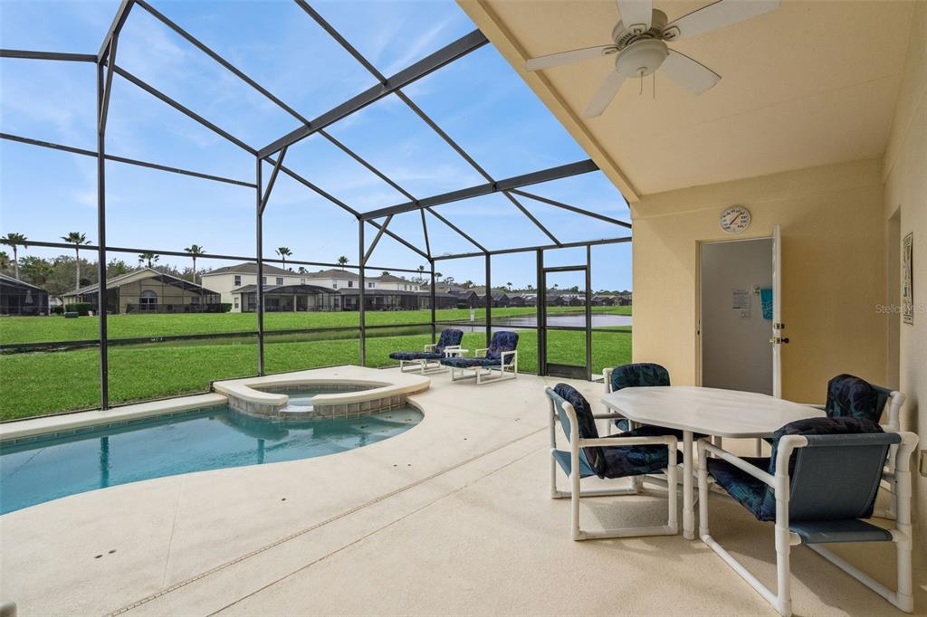 1202 Winding Cypress Court Kissimmee, FL 34746 - Photo 32 of 41 a view of a patio with a table and chairs