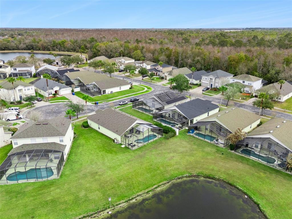 1202 Winding Cypress Court Kissimmee, FL 34746 - Photo 37 of 41 an aerial view of residential houses with outdoor space and trees