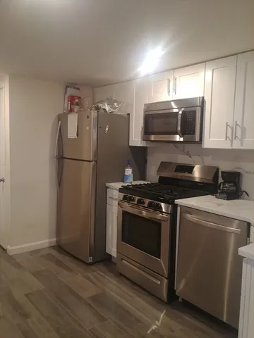 a kitchen with a stove a microwave and a refrigerator