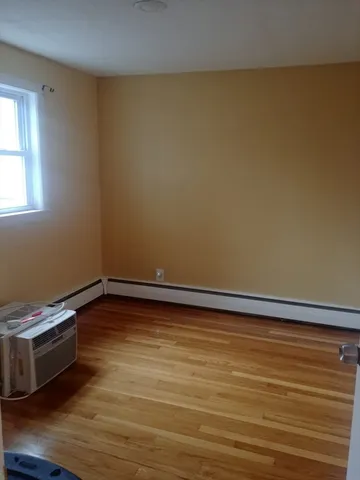 a view of an empty room and wooden floor