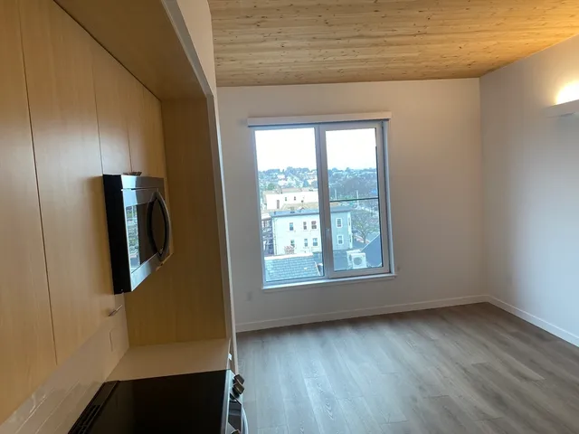 a view of a kitchen with a refrigerator and a microwave