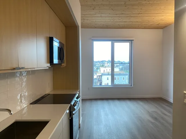 a view of a kitchen with wooden floor and a sink