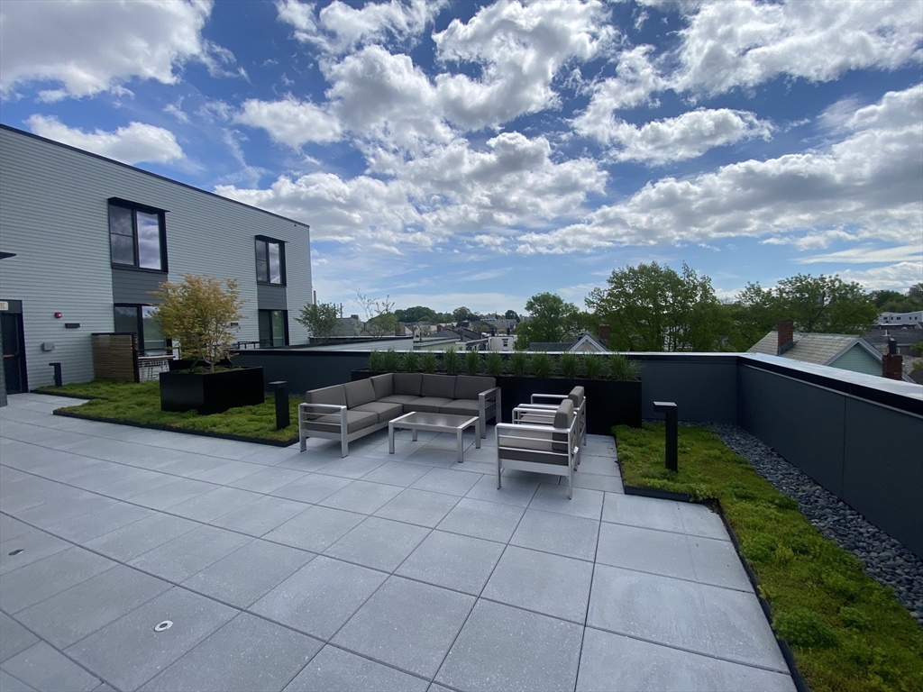 154 Broadway, Unit 507 Somerville, MA 02145 - Photo 20 of 31 a view of a terrace with sitting area