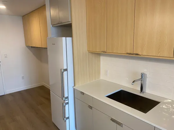 a white toilet sitting next to a bathroom sink