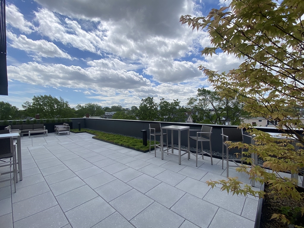 154 Broadway, Unit 507 Somerville, MA 02145 - Photo 26 of 31 a view of a terrace with sitting area