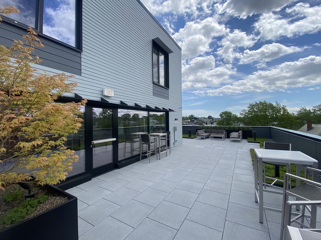 154 Broadway, Unit 507 Somerville, MA 02145 - Photo 29 of 31 a view of house with backyard and sitting area
