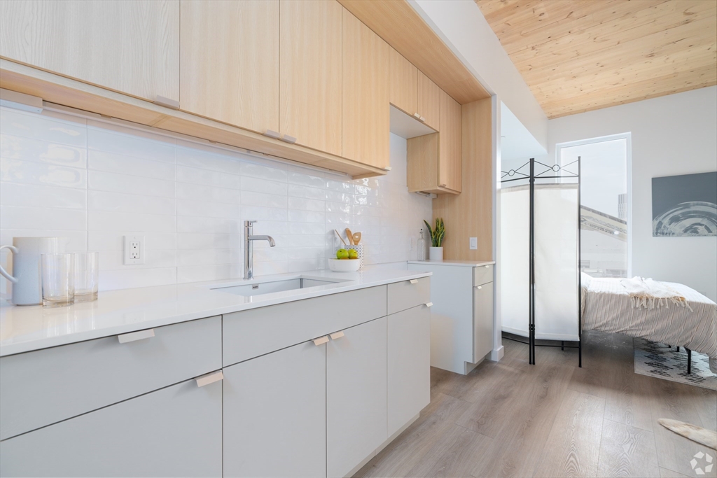154 Broadway, Unit 507 Somerville, MA 02145 - Photo 3 of 31 a kitchen with cabinets and a sink