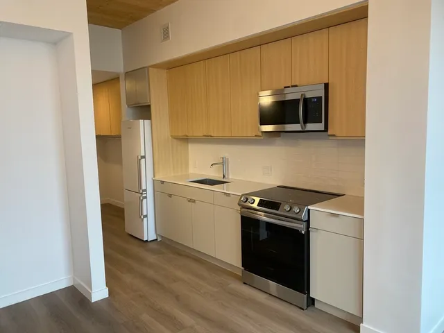 a kitchen with a stove microwave and refrigerator