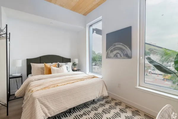 a bedroom with a bed and glass window