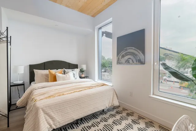 a bedroom with a bed and glass window